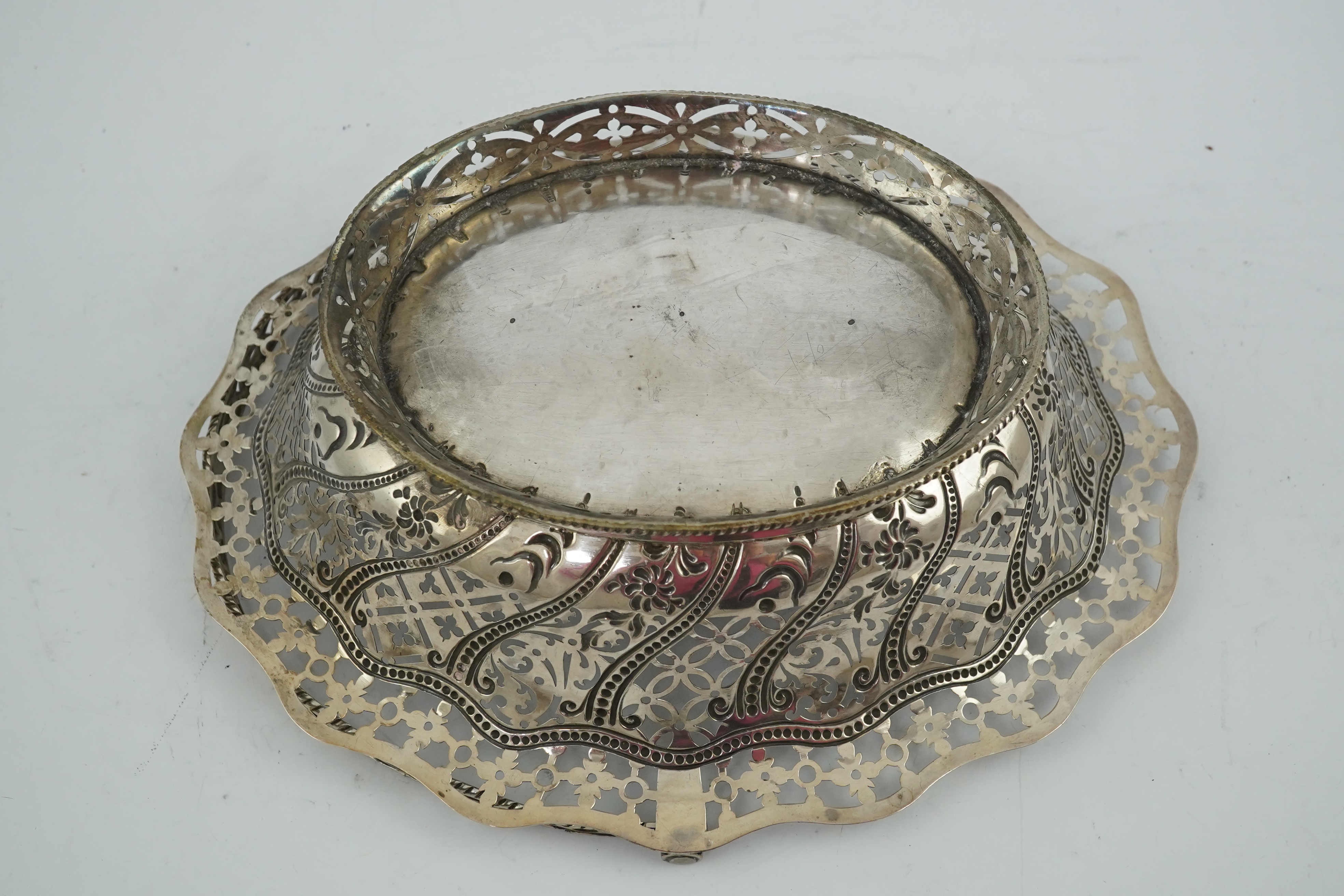 A George III pierced repousse silver cake basket